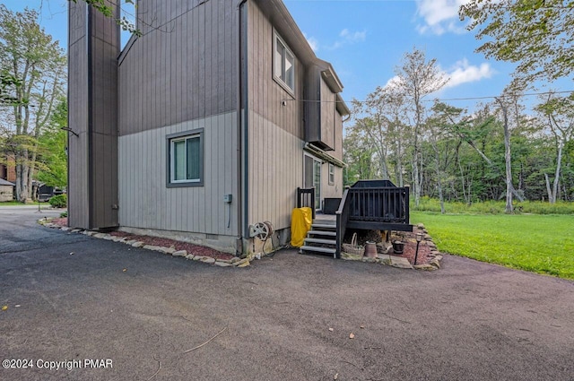 view of home's exterior featuring crawl space, a lawn, and a wooden deck