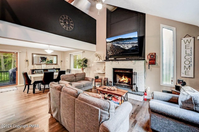 living area with a fireplace and wood finished floors