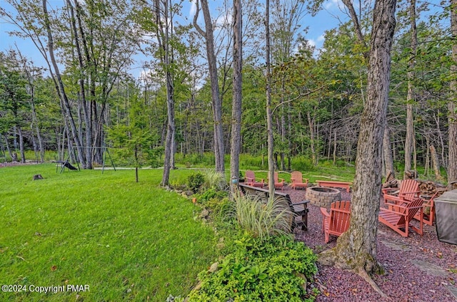 view of yard with an outdoor fire pit