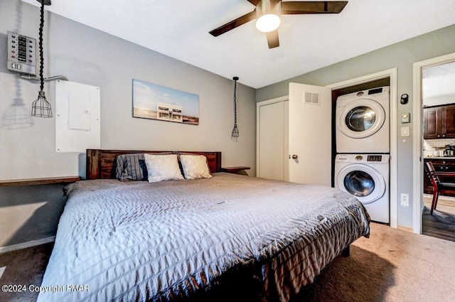 bedroom with stacked washer and dryer, carpet flooring, a ceiling fan, visible vents, and electric panel