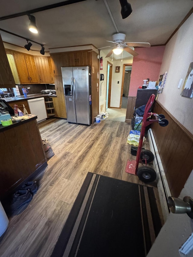 kitchen with white dishwasher, ceiling fan, brown cabinetry, light wood-style flooring, and stainless steel refrigerator with ice dispenser