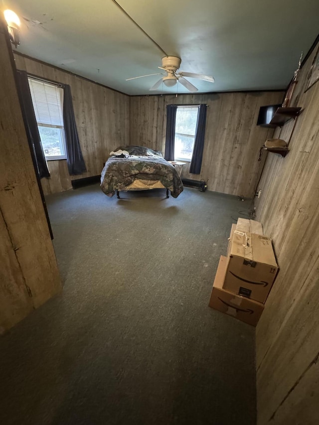 bedroom featuring wooden walls and ceiling fan