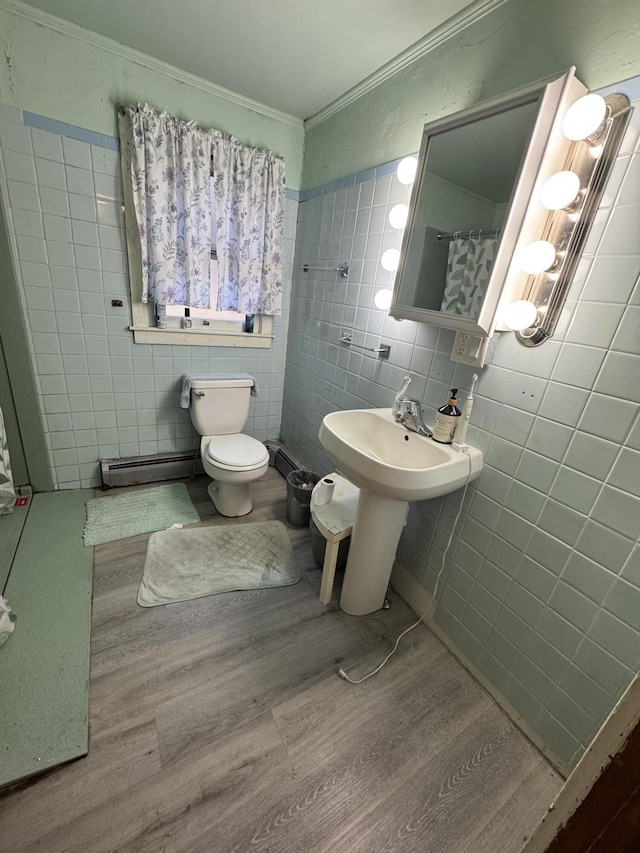 bathroom with crown molding, tile walls, toilet, and wood finished floors
