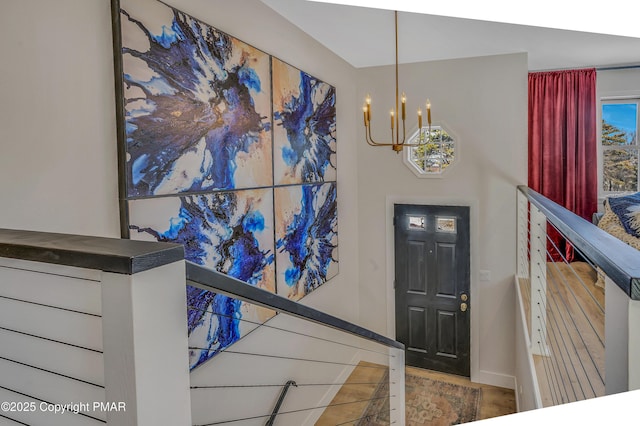 entrance foyer featuring baseboards and a notable chandelier