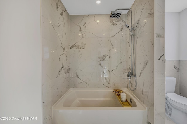 bathroom featuring toilet, tub / shower combination, and tile walls