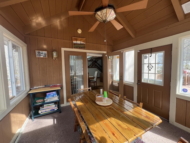 sunroom with lofted ceiling with beams, plenty of natural light, and wooden ceiling