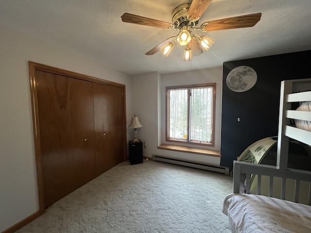 carpeted bedroom featuring a textured ceiling, ceiling fan, baseboard heating, and a closet