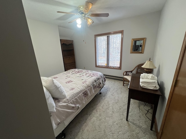 carpeted bedroom with a baseboard heating unit and a ceiling fan