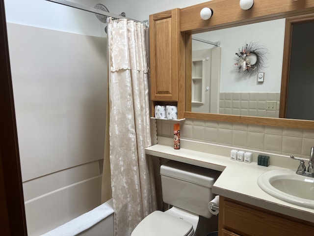 bathroom featuring toilet, tasteful backsplash, shower / tub combo with curtain, and vanity