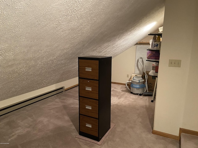 additional living space with baseboards, vaulted ceiling, a textured ceiling, carpet floors, and a baseboard heating unit