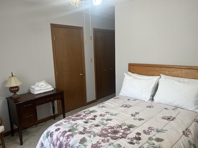 bedroom featuring baseboards and light colored carpet