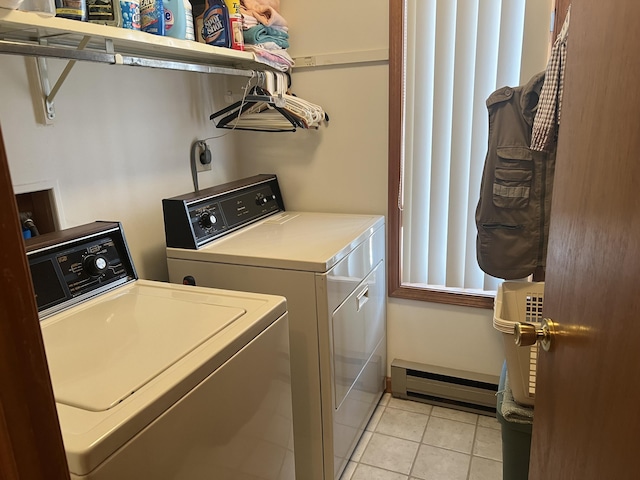 laundry area with a baseboard heating unit, laundry area, light tile patterned floors, and washer and dryer