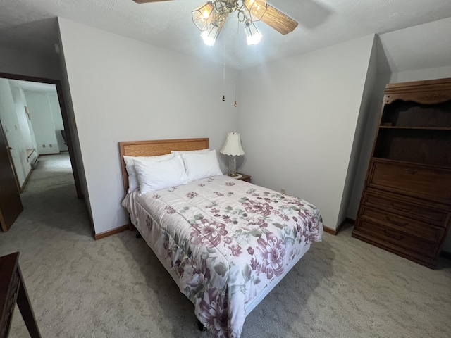 bedroom with ceiling fan, baseboards, and light colored carpet