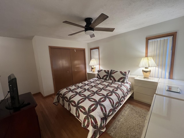 bedroom with a textured ceiling, a closet, wood finished floors, and a ceiling fan