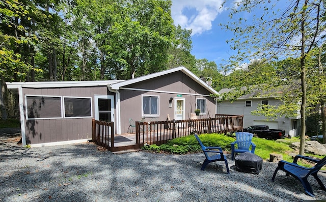 457 Maxatawny Dr, Pocono Lake, PA 18347 - back of property featuring a wooden deck, an outdoor fire pit, and a patio area