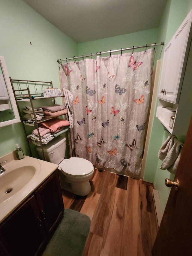 full bath featuring curtained shower, wood finished floors, toilet, and vanity