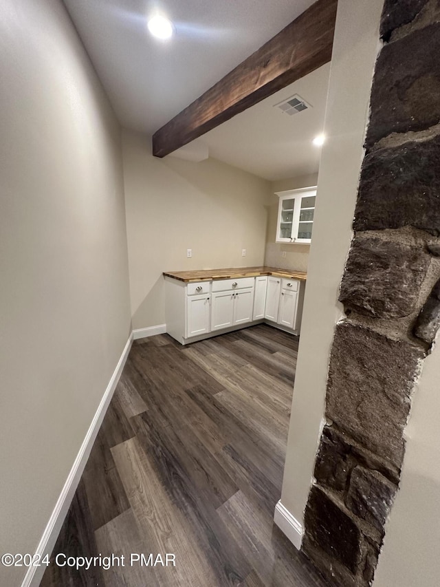 bar with dark wood-style floors, beam ceiling, baseboards, and visible vents