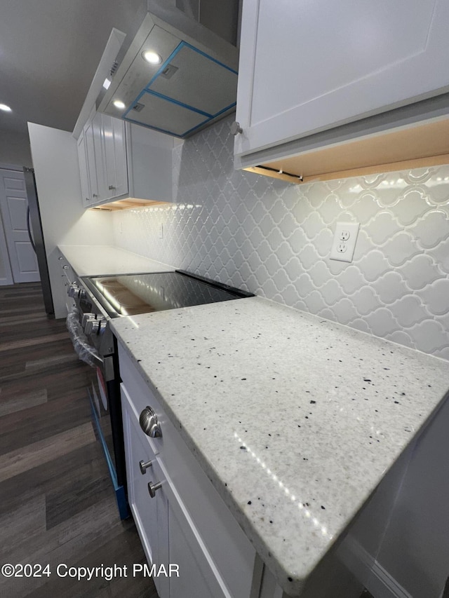 kitchen with range hood, white cabinetry, stainless steel electric range, and dark wood-style flooring