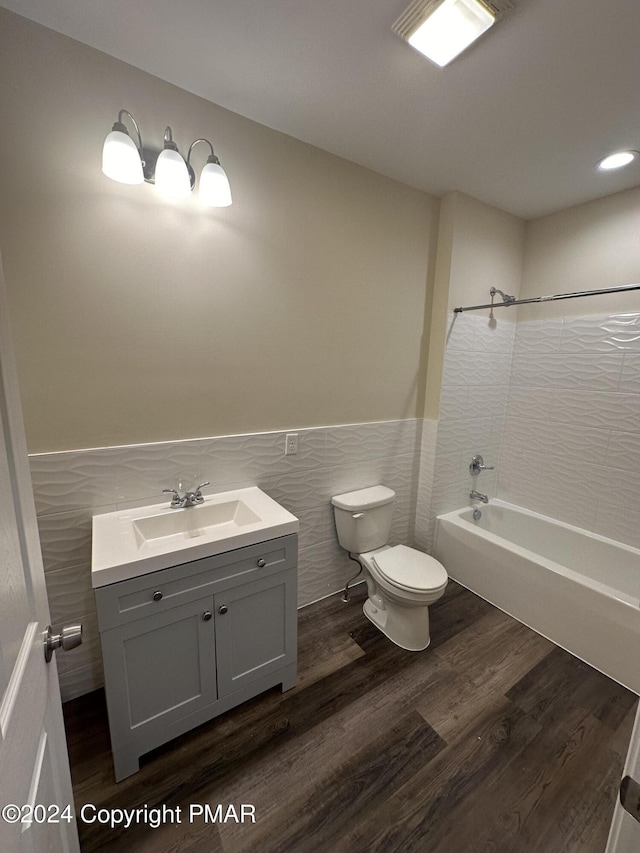 bathroom featuring a wainscoted wall, toilet, wood finished floors, and vanity