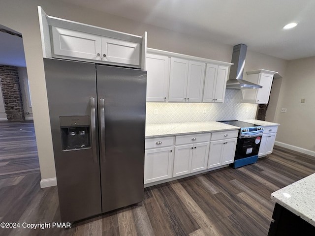 kitchen with stainless steel appliances, dark wood-type flooring, backsplash, wall chimney range hood, and white cabinets