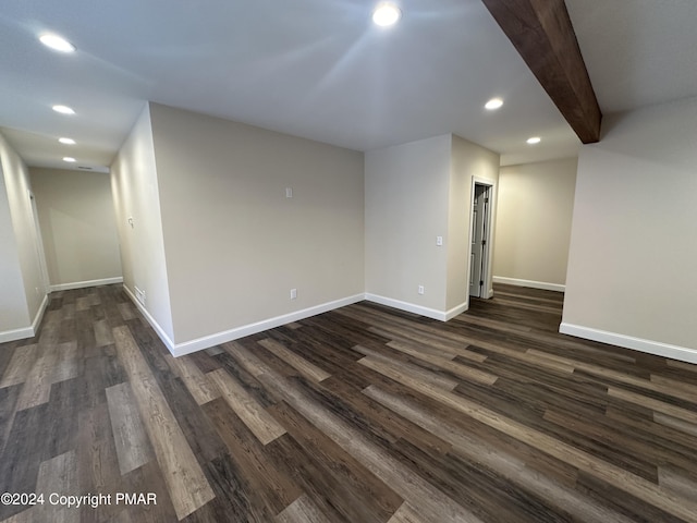 spare room with baseboards, dark wood-style flooring, recessed lighting, and beamed ceiling