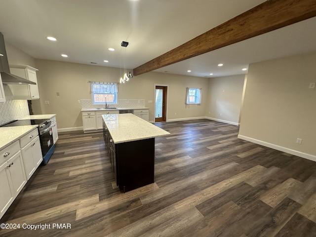 kitchen with dark wood-type flooring, backsplash, a kitchen island, stainless steel range with electric cooktop, and beamed ceiling