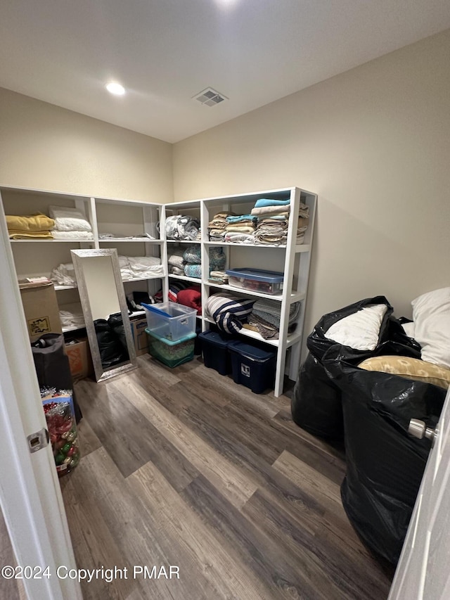 bedroom featuring wood finished floors and visible vents