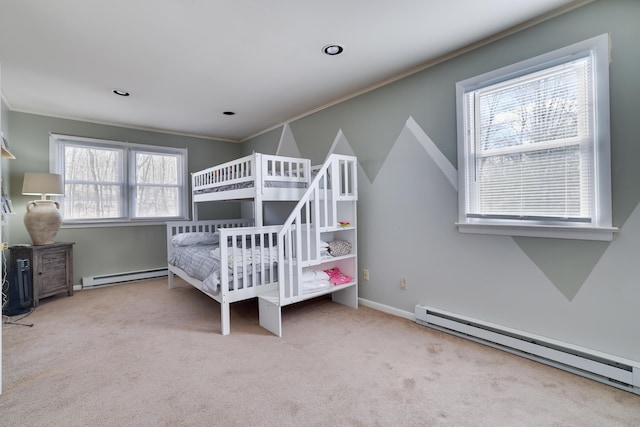 bedroom featuring a baseboard heating unit, carpet flooring, crown molding, and baseboards