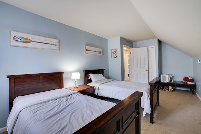 bedroom with vaulted ceiling and light colored carpet