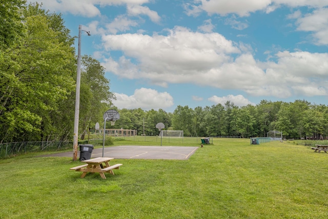 view of sport court featuring community basketball court, a yard, and fence