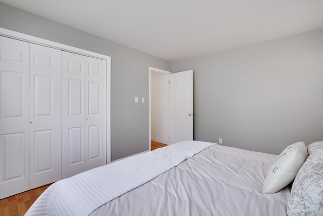 bedroom featuring a closet and light wood-style floors