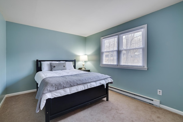 carpeted bedroom with a baseboard radiator and baseboards