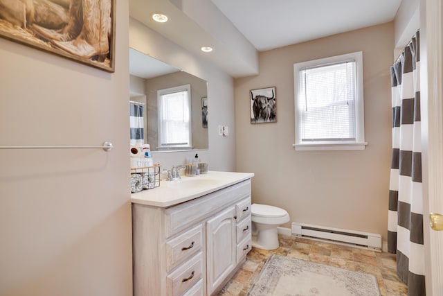 bathroom with toilet, a baseboard radiator, curtained shower, stone finish flooring, and vanity