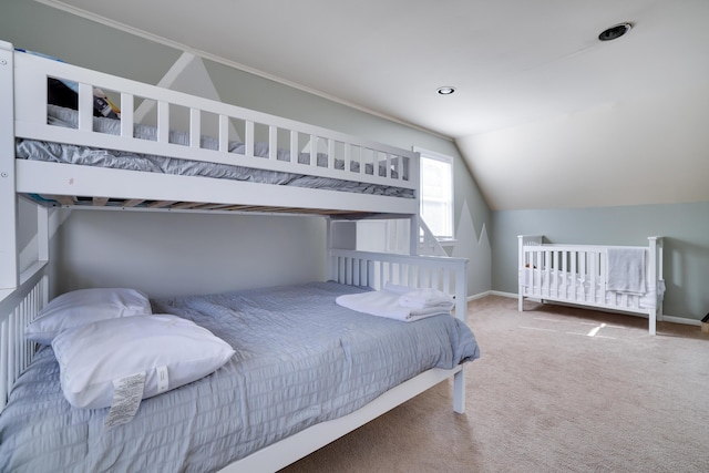 carpeted bedroom with lofted ceiling and baseboards