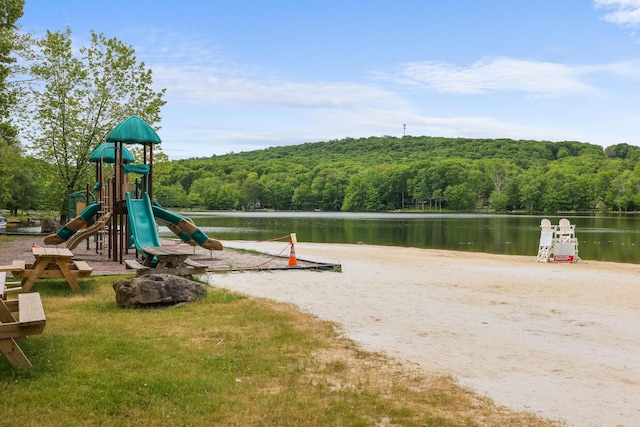 community play area featuring a water view and a view of trees