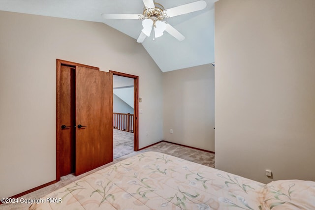 unfurnished bedroom with a ceiling fan, baseboards, lofted ceiling, a closet, and light carpet