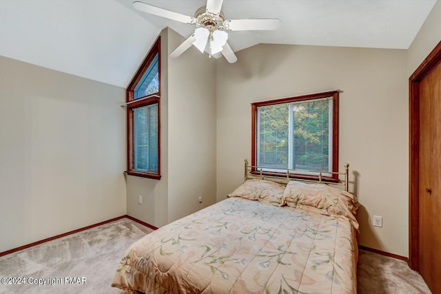 bedroom featuring lofted ceiling, carpet, baseboards, and ceiling fan