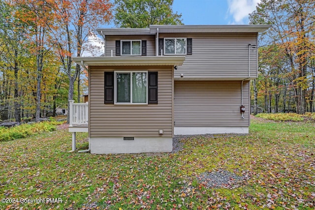 back of house with a lawn