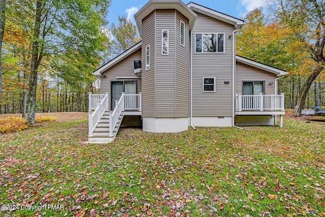 back of property featuring crawl space and a yard