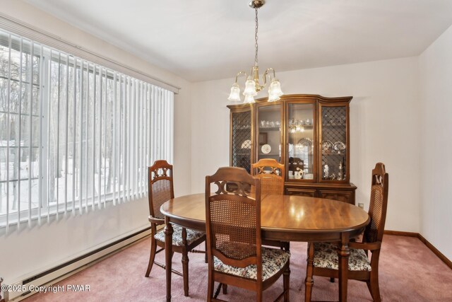 dining room with an inviting chandelier, a baseboard heating unit, and carpet flooring