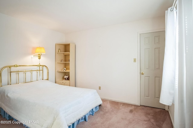 bedroom featuring light carpet