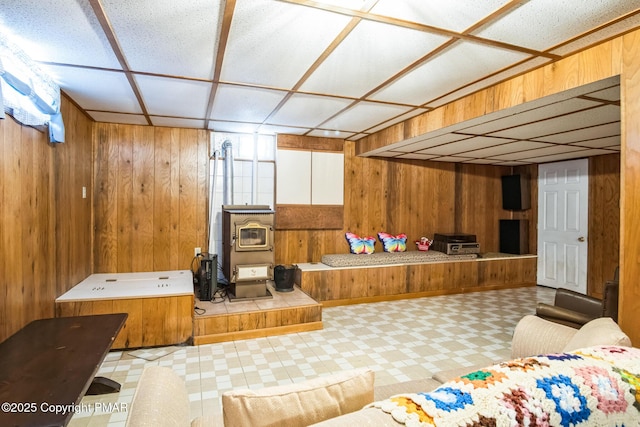 kitchen with a wood stove and wooden walls