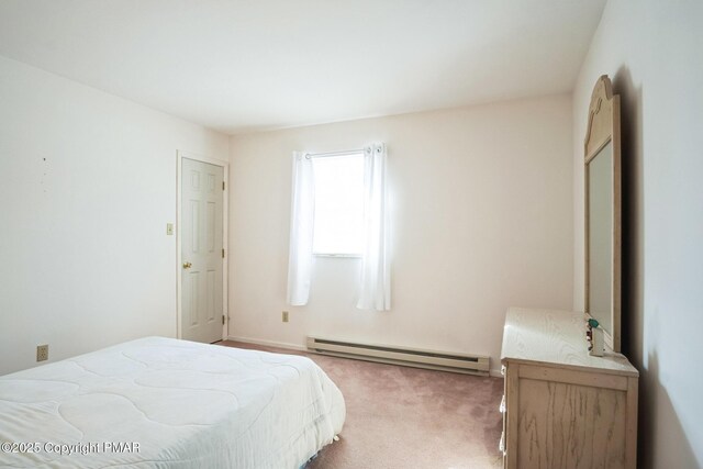 carpeted bedroom featuring a baseboard heating unit