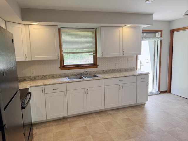 417 Lower Swiftwater Rd, Cresco, PA 18326 - kitchen featuring a sink, black range, freestanding refrigerator, backsplash, and white cabinets