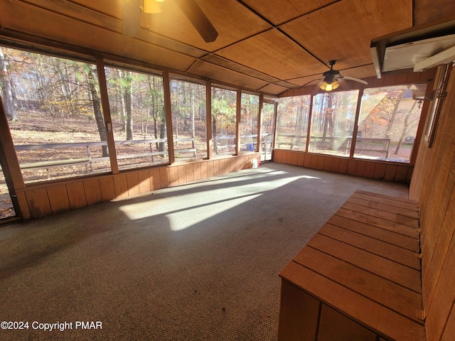 unfurnished sunroom with plenty of natural light and a ceiling fan