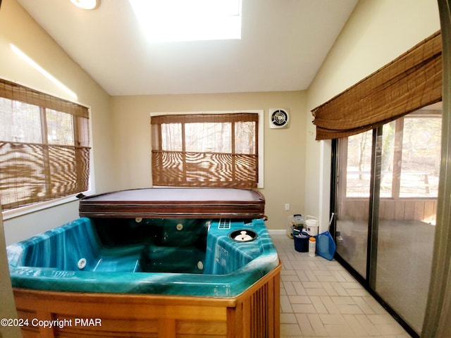 recreation room with plenty of natural light, lofted ceiling, and a jacuzzi