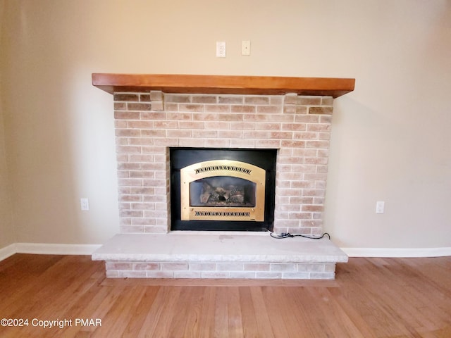 details featuring baseboards, wood finished floors, and heating unit