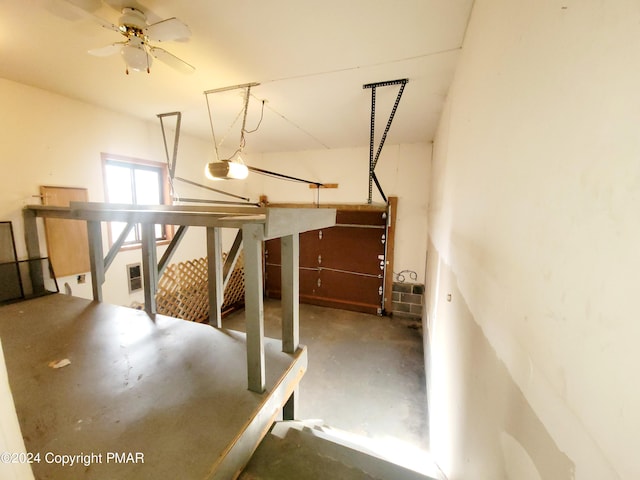 garage with a ceiling fan and a garage door opener