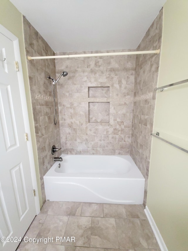 full bath featuring tile patterned flooring, bathtub / shower combination, and baseboards