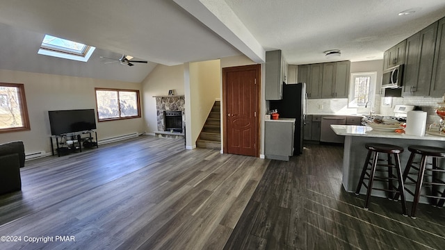 kitchen featuring plenty of natural light, appliances with stainless steel finishes, open floor plan, and light countertops